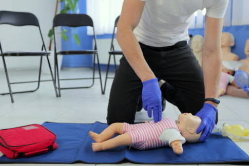 CPR being performed on a baby manikin